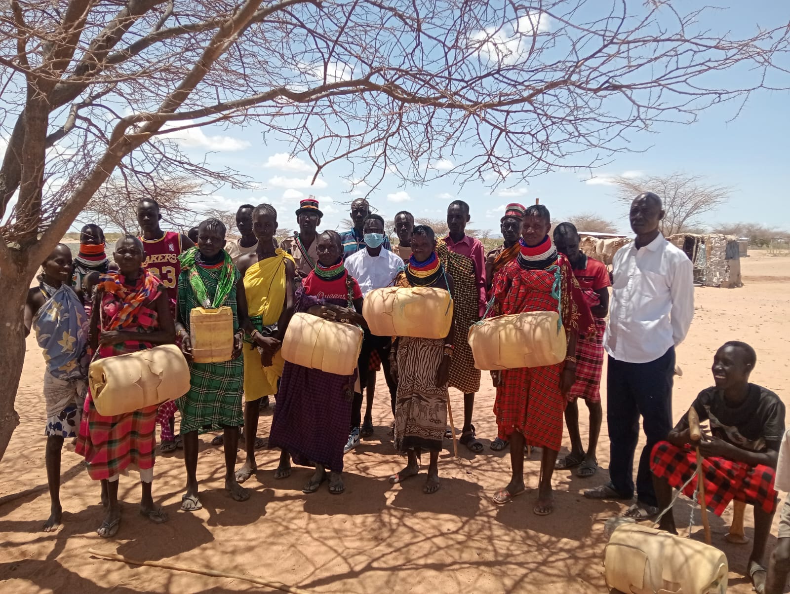 Community members gathered with water containers in the arid Kalotum area of Turkana County, Kenya