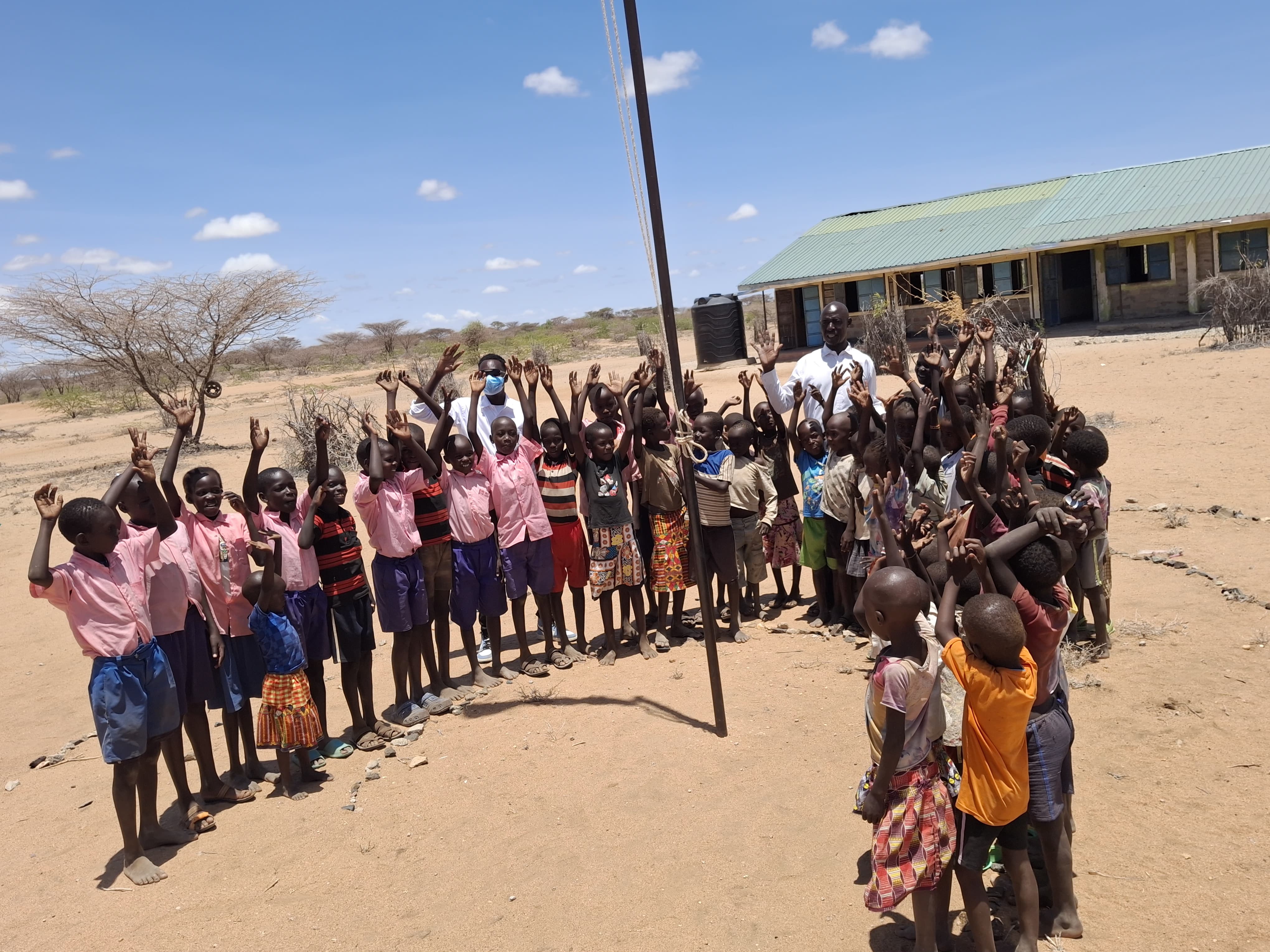 Students and staff gathered outside Kalotum Primary School in the arid landscape of Turkana County, Kenya